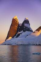 Lemaire strait coastal landscape, mountains and icebergs, Antarctic Peninsula, Antartica. photo
