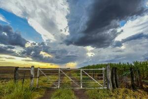 Countryside gate Stormy with a stormy sky in the background, La Pampa province, Patagonia, Argentina. photo