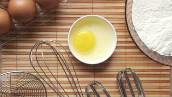 flour, eggs, whisk, and other ingredients on a table video
