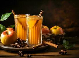 A glass of cider on wooden table with spices photo