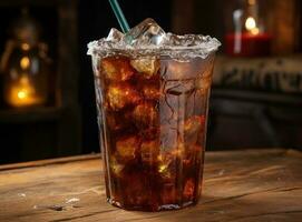 An ice cola in a glass on a sack table photo