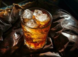 An ice cola in a glass on a sack table photo