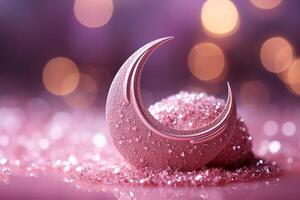 Moon with pink glitter effect with light vermilion background with small defocused sparkles. photo