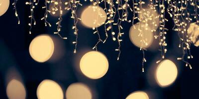 Pale yellow lights bokeh from christmas holiday garlands, blurred festive abstract background lights photo