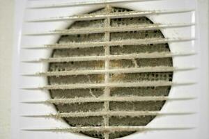 Dirty air ventilation grill of HVAC with clogged filter. photo