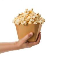 Hand holding bucket of popcorn Isolated on White Background AI Generated photo
