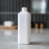 A white bottle of shampoo stands on the table in bathroom. photo