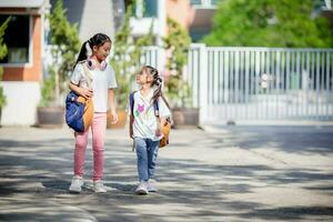 Back to school. Cute Asian child girl with a backpack running and going to school with fun photo