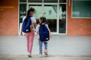 Back to school. Cute Asian child girl with a backpack running and going to school with fun photo