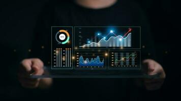 Data analyst working on business analytics dashboard with charts, metrics and KPI to analyze performance and create insight reports and strategic decisions for operations management on virtual screen. photo