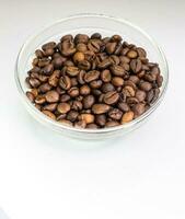 Bowl of coffee beans on white background photo