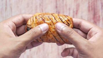 a person holding a pastry in their hand video