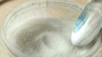 a spoon is being used to scoop out sugar from a jar video