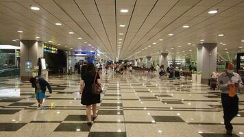 people walking through an airport terminal with luggage video