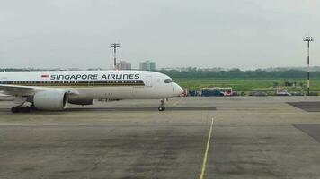 a singapore airlines airplane parked on the tarmac at an airport video