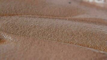 a close up of chocolate ice cream surface video