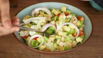uma tigela do salada com cebolas, abacate e de outros legumes video