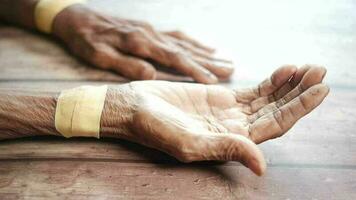 an elderly woman's hands with tape on them video