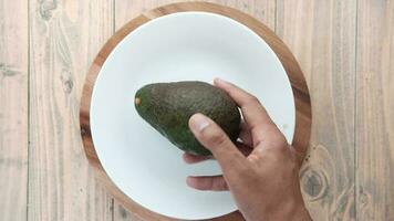 a person holding an avocado on a plate video