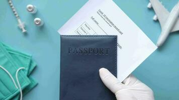 a person in a medical mask holding a passport video