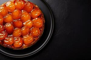 Delicious Tarte Tatin dark background with empty space for text photo