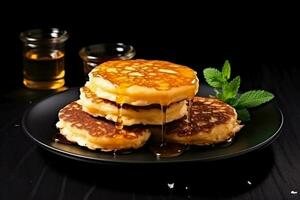 couple of puff cottage cheese pancakes with honey dark background with empty space for text photo