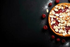 Delicious Bakewell Tart dark background with empty space for text photo
