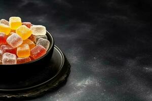 Delicious gumdrops dark background with empty space for text photo