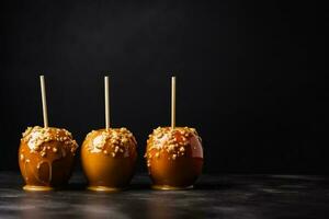 Delicious Caramel Apples dark background with empty space for text photo