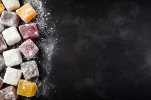 Delicious Turkish Delight dark background with empty space for text photo