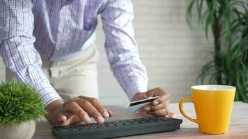 a man is using a keyboard and a credit card video