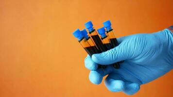 a person in blue gloves holding test tubes on orange background video