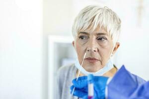 Close-up of senior woman getting PCR test at doctor's office during coronavirus epidemic. photo