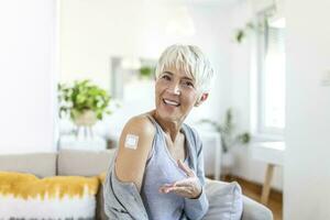 Adhesive bandage on arm after injection vaccine or medicine,ADHESIVE BANDAGES PLASTER - Medical Equipment,Soft focus Adhesive bandage on a female brachium after covid-19 vaccination photo