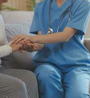 Asian doctor woman visited patient woman to diagnosis and check up health at home or private hospital. Female patient explain health problem and symptoms to doctor .Health care premium service at home photo