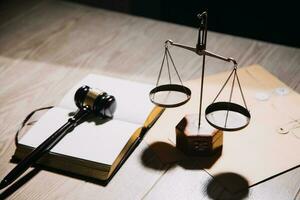 Justice and law concept.Male judge in a courtroom with the gavel, working with, computer and docking keyboard, eyeglasses, on table in morning light photo