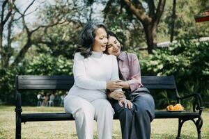 Happy senior woman enjoying in daughter's affection on Mother's day. photo