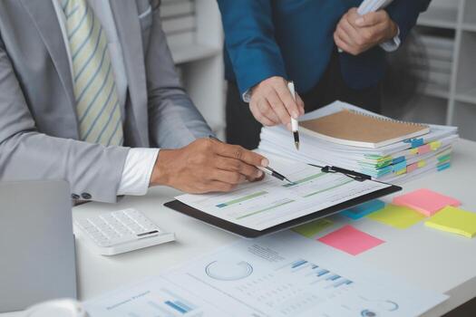 Financial analysts analyze business financial reports on a digital tablet planning investment project during a discussion at a meeting of corporate showing the results of their successful teamwork. photo