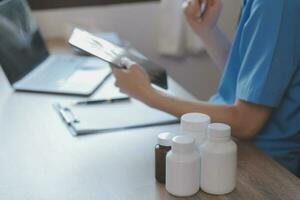 Close-up of stethoscope and paper on background of doctor and patient hands photo