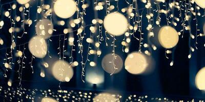 Pale yellow lights bokeh from christmas holiday garlands, blurred festive abstract background lights photo