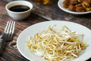 Mung bean sprouts in plate. Raw organic healthy food. Traditional vegetable dish in east Asia. photo