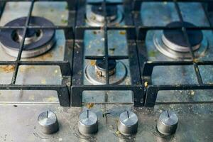 Dirty gas stove with food leftovers and crumbs photo