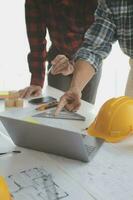 Construction and structure concept of Engineer or architect meeting for project working with partner and engineering tools on model building and blueprint in working site, contract for both companies. photo