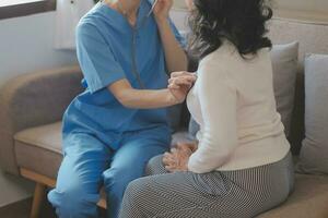 Close-up of stethoscope and paper on background of doctor and patient hands photo