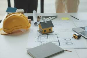 Construction and structure concept of Engineer or architect meeting for project working with partner and engineering tools on model building and blueprint in working site, contract for both companies. photo
