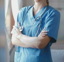 Close-up of stethoscope and paper on background of doctor and patient hands photo