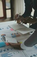Financial analysts analyze business financial reports on a digital tablet planning investment project during a discussion at a meeting of corporate showing the results of their successful teamwork. photo
