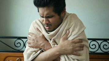 a man is wrapped in a towel and holding his chest video