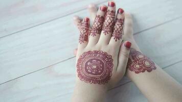 a woman's hands with henna designs on them video