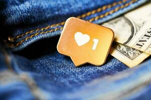 Like heart symbol and dollar in jeans pocket photo